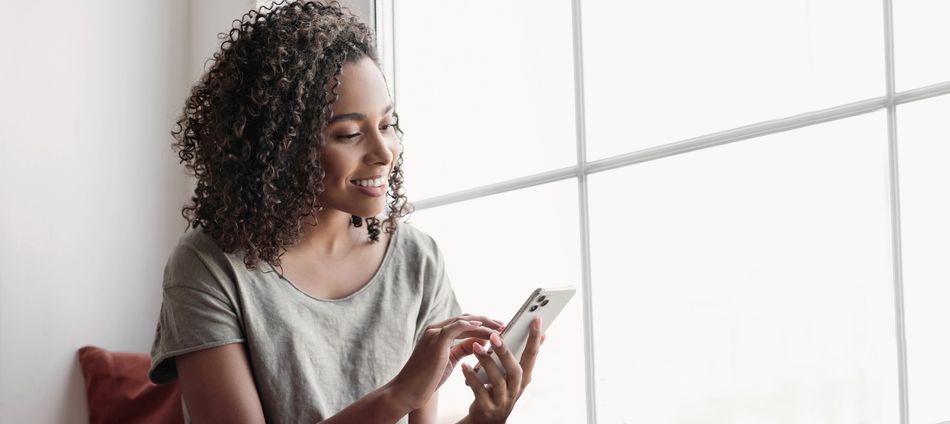 Young woman resting at home with smartphone, beautiful girl looking at phone panoramic banner, Online communication, relaxation, connection, social distancing, technology, leisure lifestyle concept