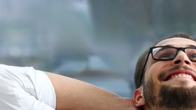 Handsome smiling bearded adult clerk person arms crossed