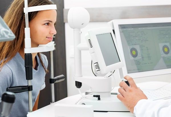 Teenage girl undergoes eye survey on special examination comuter in the ophthalmologic clinic