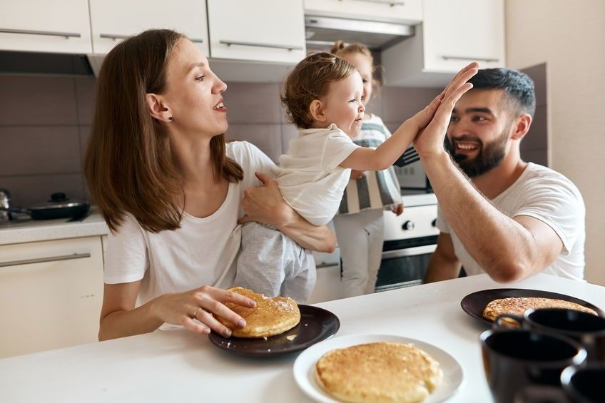 little girl giving high five to her adoirable bearded dad