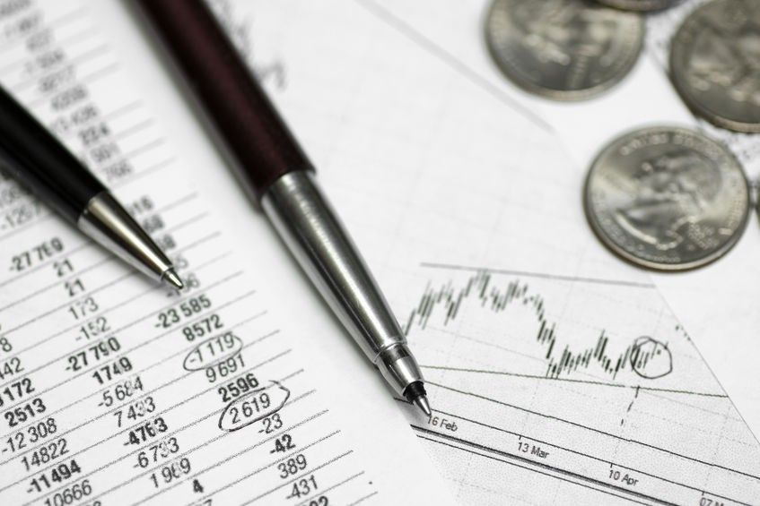 pen on paper with the price quotes and charts