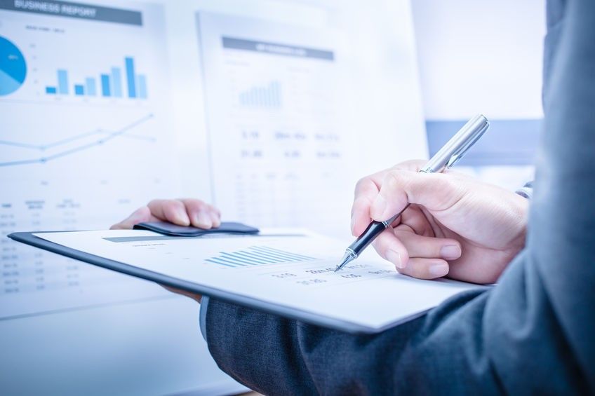 Businessman analyzing investment charts. Accounting