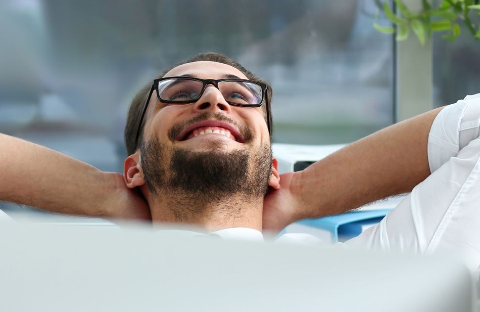 Handsome smiling bearded adult clerk person arms crossed
