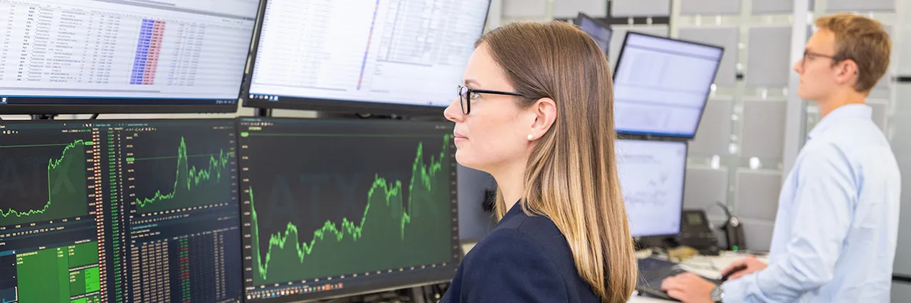 Zwei Menschen an Monitoren in der Wiener Börse