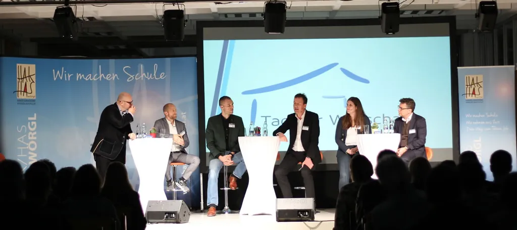 sechs Personen reden bei Stehtisch auf der Bühne 