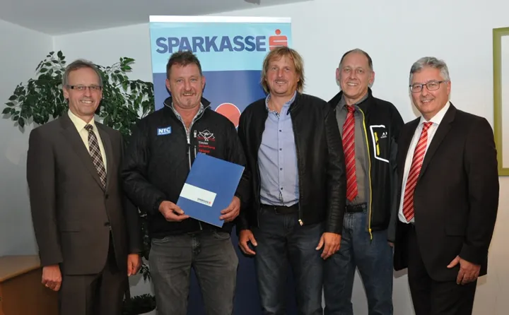 fünf Männer lachen stehend in die Kamera