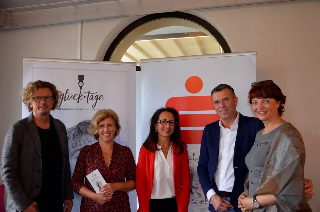 drei Frauen und zwei Männer lachen in die Kamera