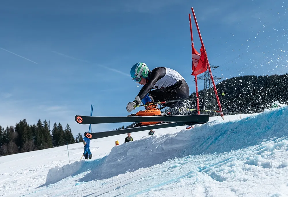 Skifahrer während dem rennen bei Sprung 